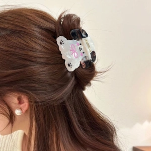 Cute acetate puppy hair claw clip with pink bow worn on hair for styling decoration