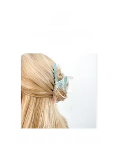 Detail of light blue gradient acetic acid shark clip on long blonde hair for vacation