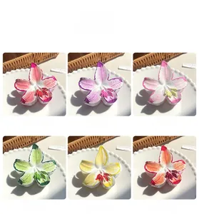 Détails des pinces à cheveux en forme de lis déclinées en violet, rose, vert et jaune