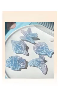Detailed macro view of 5-piece marine themed hair claw clips with blue marble texture