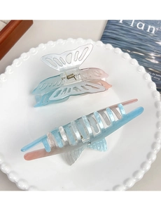 Detail of blue and pink gradient butterfly hair claws with pearlescent finish on tray