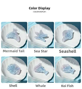 Detailed view of six ocean-themed ice blue hair clips including starfish and mermaid tail