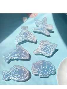 Detailed close-up of ocean-themed hair clips with pearl purple gradient and glossy finish