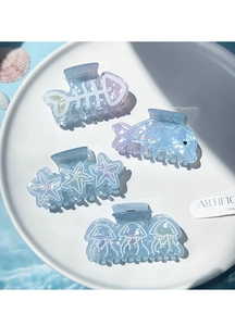 Detail of aquatic hair clips featuring starfish and dolphin shapes in gradient blue ocean theme