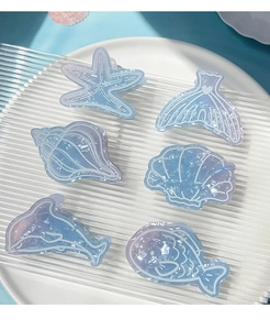 Detailed set of 6 ocean-themed PVC hair clips featuring starfish and blue whale designs