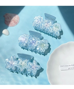 Detailed set of three ocean-themed hair claws featuring jellyfish, shell, and starfish designs