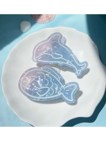 Close-up of blue gradient dolphin and round fish hair clips with marble texture