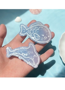 Detail of blue gradient fish and dolphin hair clips with pearlescent acetate finish