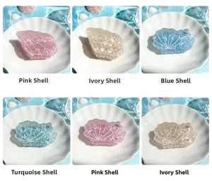 Close-up of ocean-themed hair clips with pearl luster finish and rhinestone details