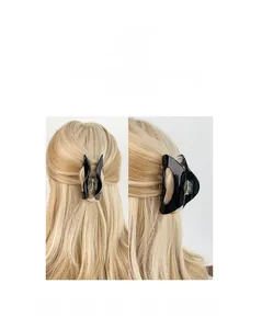 Detail view of a black glossy acetate hair claw clip styled on blonde hair from two angles