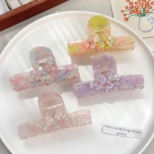 Floral acetate hair claws with rhinestones and marble texture in four soft colors