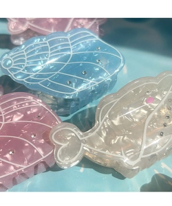 Detail of acetate whale and shell hair claws with pearlescent finish and rhinestones
