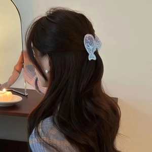 Cute gradient blue fish-shaped PVC claw clip for hair styling shown in lifestyle setting