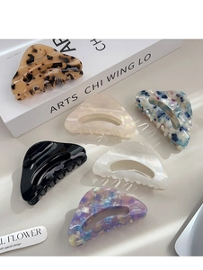 Detail of hollow triangle acetate hair claws in various elegant marble and leopard patterns