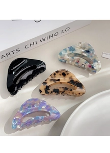 Detail view of four acetic acid hair claws in floral and tortoiseshell patterns