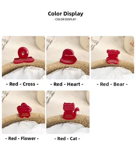 Detailed set of five red resin mini hair claws in heart, flower, and bear shapes