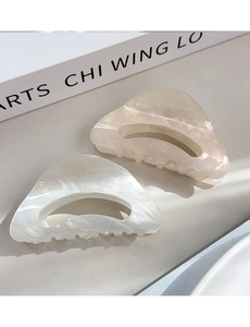 Close-up of marble texture acetate hair claws with hollow triangle design for women