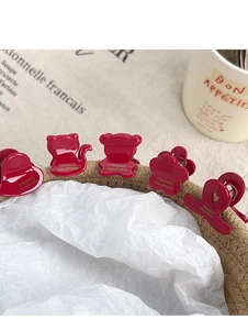 Macro view of five red acetate hair clips with France Handmade gold lettering detail