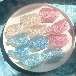 Ocean-themed hair clips set with whale and shell shapes in pastel acetate finish
