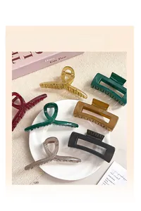 Close-up of matte jelly hair claws in various colors displayed on a white plate