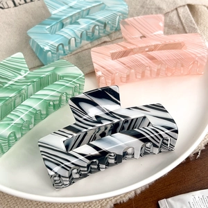 Large striped candy-colored hair claws in marble and stripe patterns for women