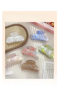 Detailed set of floral rhinestone hair claw clips in assorted pastel marble colors