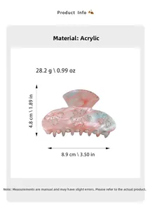 Detail view of acrylic hair claw clip with pink marble finish and rhinestone flower accents
