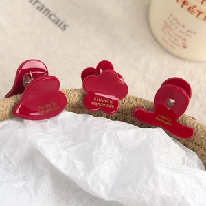 Set of 3 vintage red acetate hair claws with heart, flower, and bow shapes
