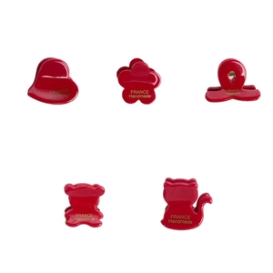 Five-piece red resin hair claw set with heart, flower, bear and cat shapes with gold lettering