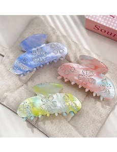 Detailed set of three marble-patterned hair claws with sparkling rhinestone flower accents