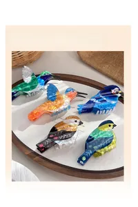 Detailed close-up of colorful acetate bird hair claw clips with marble texture