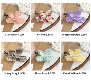 Macro view of 9.5cm floral acetate hair claws with rhinestones in six assorted colors