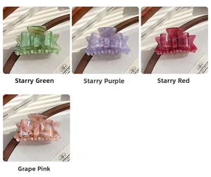 Detail view of four acetate bow hair claws in starlight green, purple, red and pink