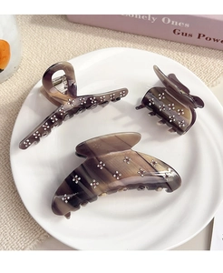 Detailed set of three brown marble acetate hair claws with sparkling rhinestone flowers