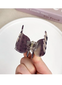 Detail of purple acetate butterfly hair claw clip with strong metal spring mechanism