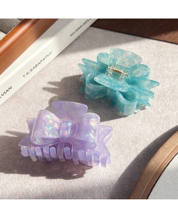 Close-up of acetic acid bow hair claws in iridescent light blue and purple marble textures