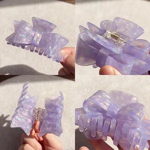 Purple iridescent acetate bow hair claw clip with glitter finish and strong metal spring
