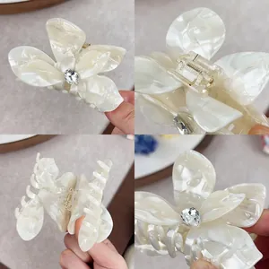 Elegant acetate butterfly hair claw with crystal rhinestone and pearl texture finish