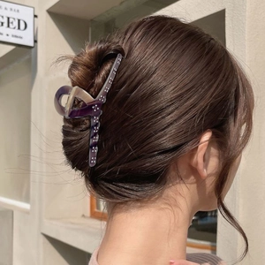 French style acetate claw clip with purple marble pattern and rhinestones on bun hair