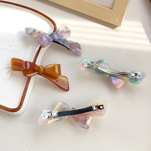 Set of four French acetate bow hair clips with elegant marble and amber patterns