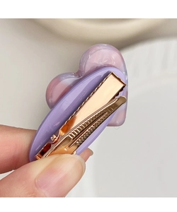Detail of heart-shaped marble resin hair clip with rose gold metal duckbill clamp