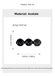 Detail of black puppy hair clip with three dog heads made of acetic acid material