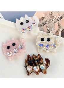 Close-up of colorful cat-shaped acetate hair clips with crystal heart decorations