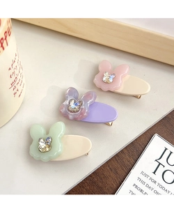 Close-up of cute acetate rabbit hair clips with sparkling rhinestone butterfly accents