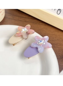 Macro detail of star-crystal acetate hair clips with five-petal flower design for girls