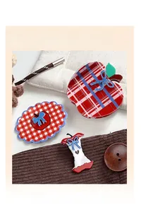 Detailed view of red plaid apple hair claw clips with blue polka dot bows and patterns