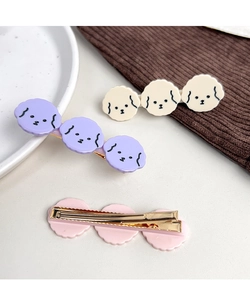 Detail of cute cartoon puppy hair clips with acetate finish and secure metal duckbill grip