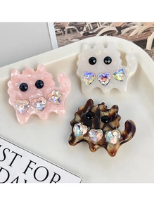 Detail of cute cat hair clips in pink marble, pearl white and tortoiseshell with rhinestones