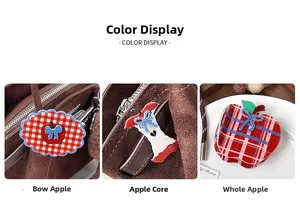 Detailed views of red plaid apple hair clips with striped blue bows on warm velvet background