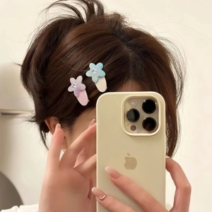Cute star-shaped acetate hair clips with rhinestone accents for girls in pink and blue